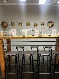 a bar with stools and plates on it