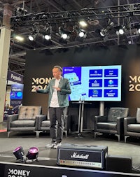 a man standing on stage at a convention